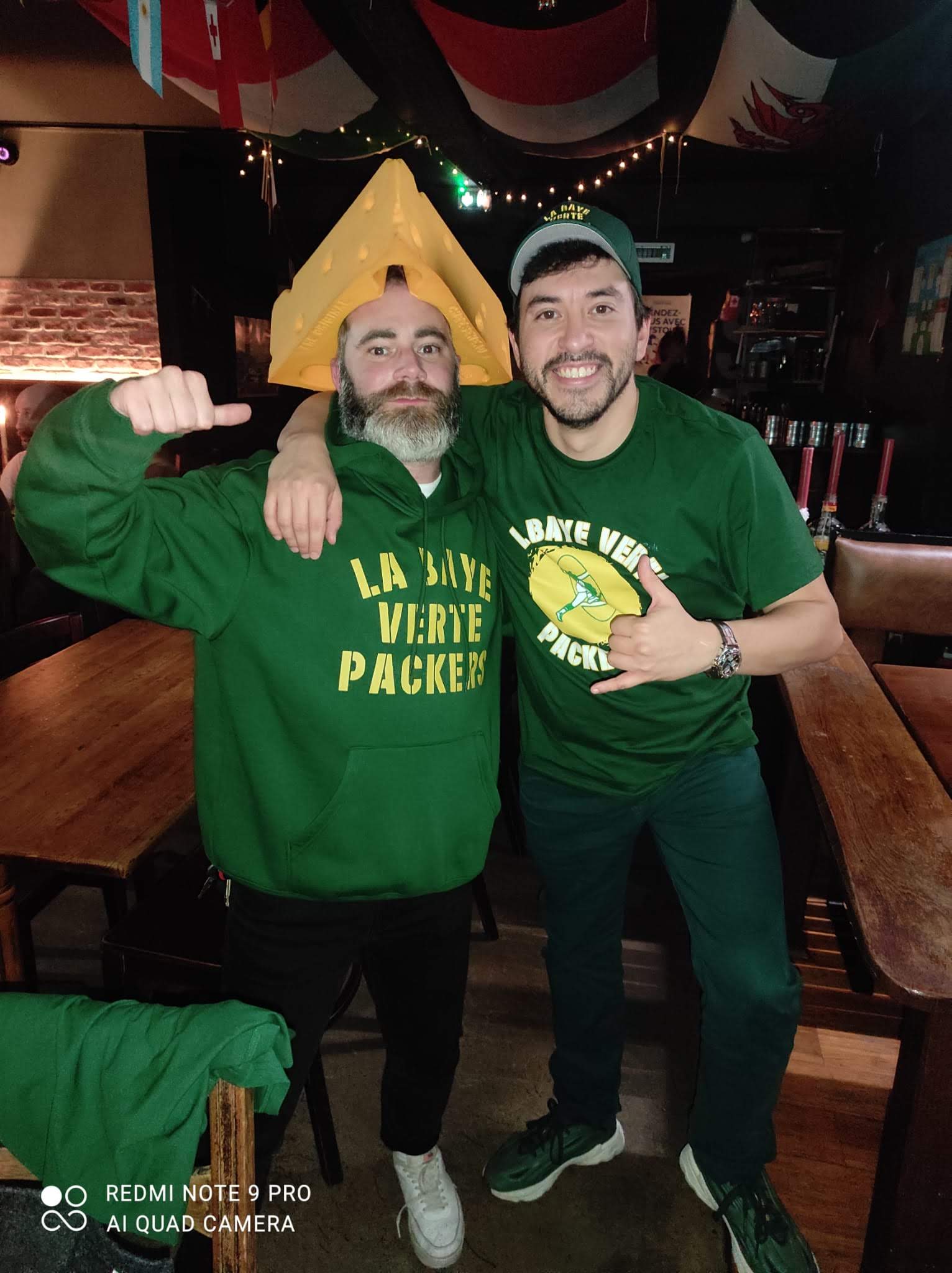 Two Titletown Europe fans in Packers green at a Paris gathering