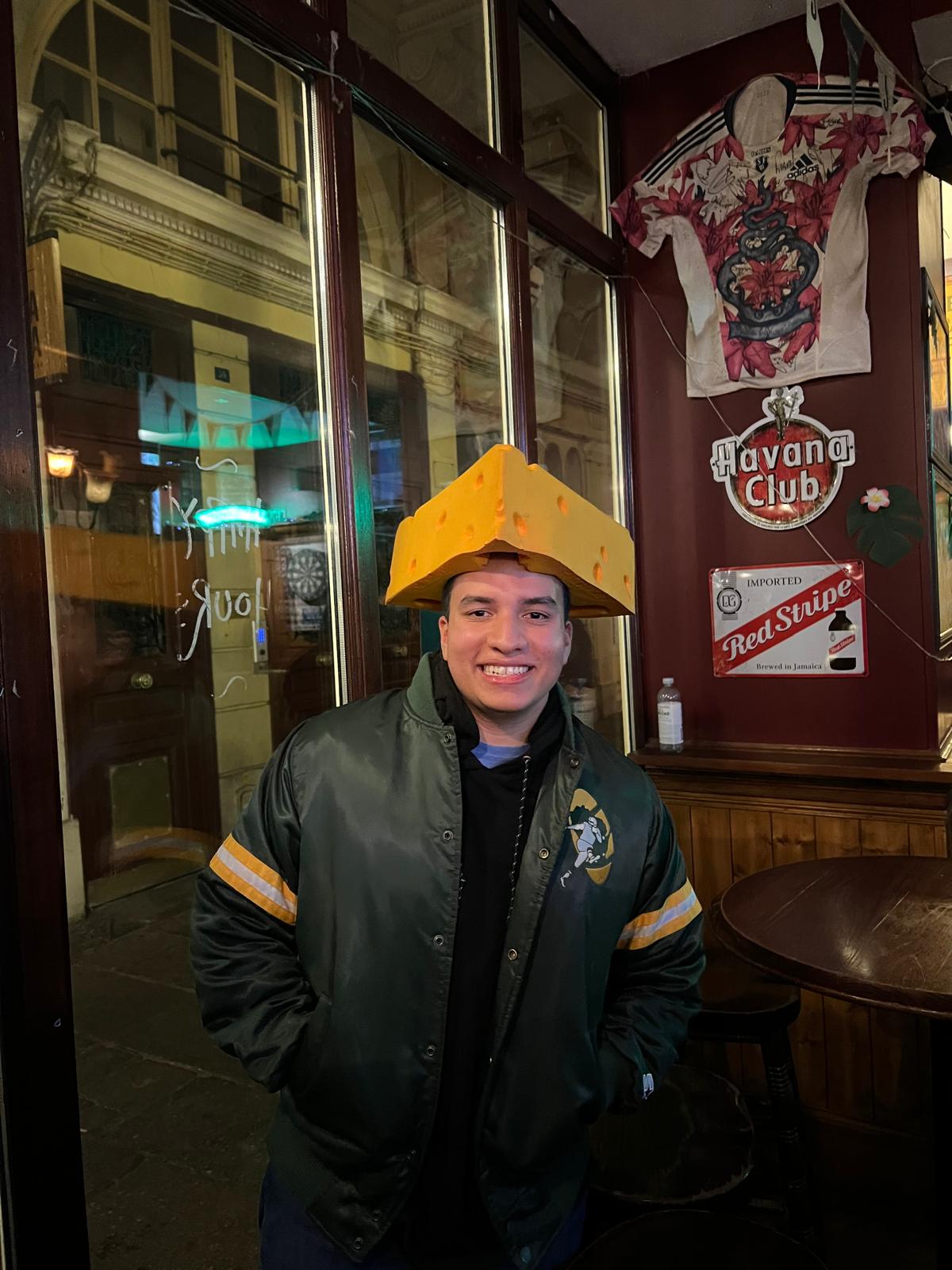 A fan wearing a cheesehead at a Paris Packers pub